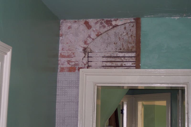 A branded card in fresh green introducing a list of nine things commonly found behind the walls of old houses during renovation.