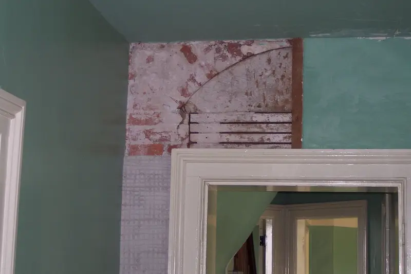 A branded card in fresh green introducing a list of nine things commonly found behind the walls of old houses during renovation.
